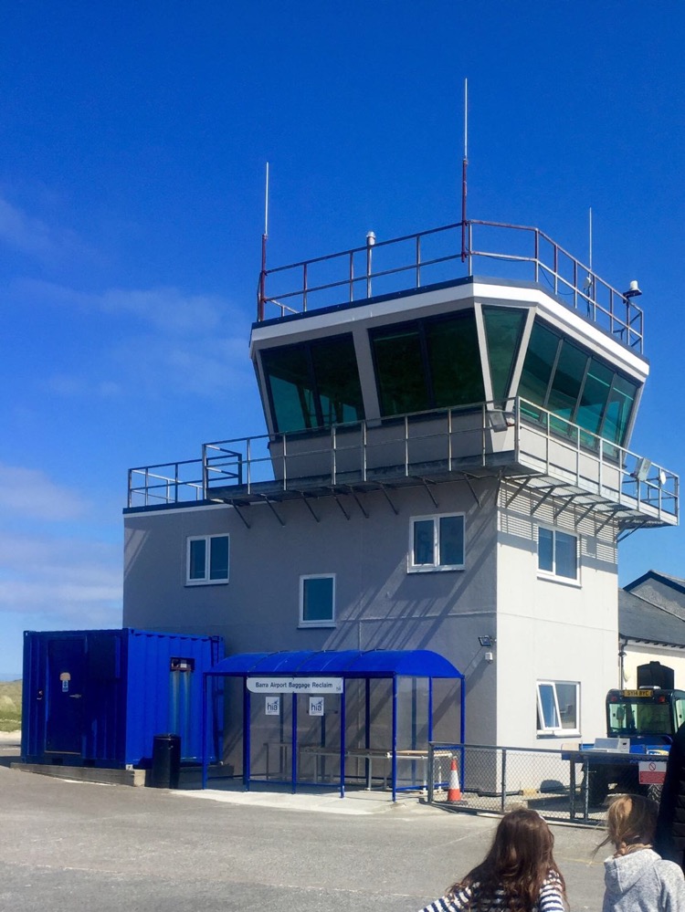 The control tower at Barra Airport with baggage reclaim in front.