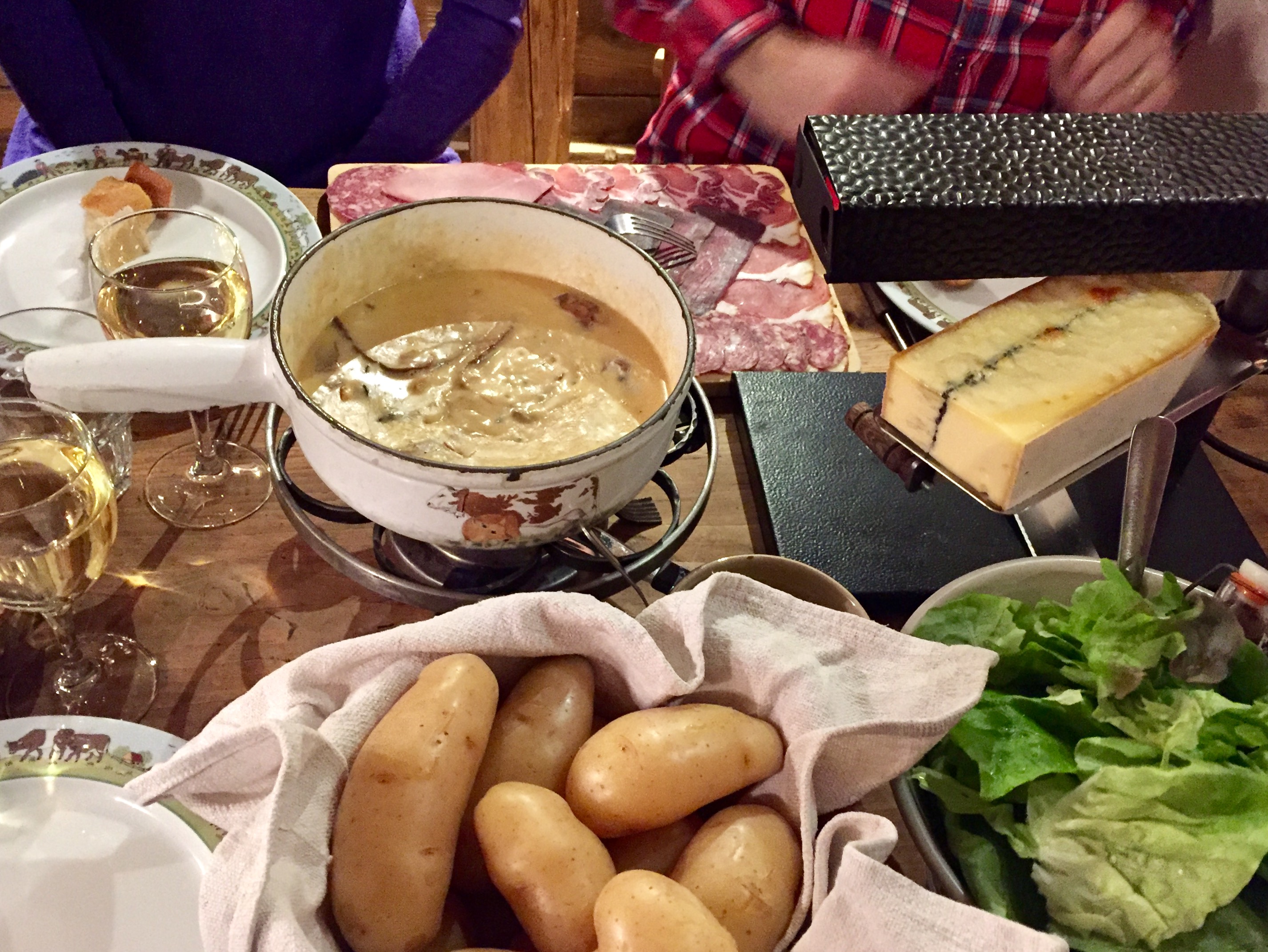 Traditional Savoyard food of fondue and raclette at the Fruitière des Perrières, Les Gets.