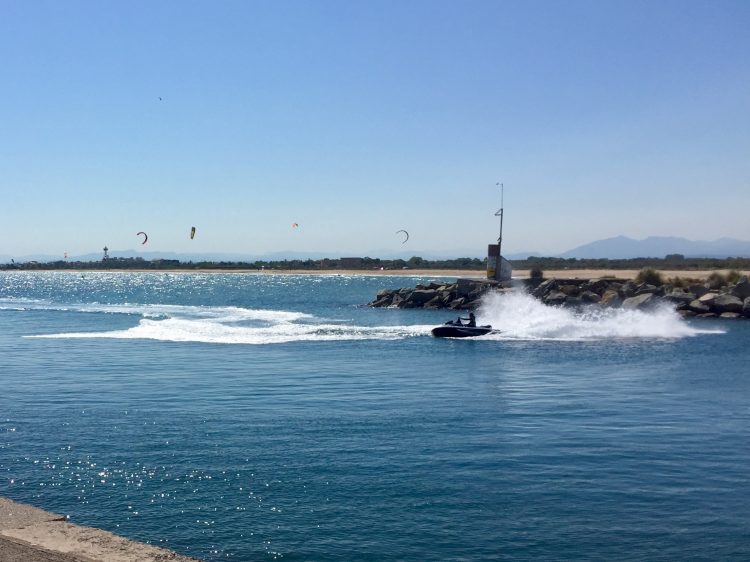 Jet-skis, windsurfers and kite-surfers at Roses, Spain.