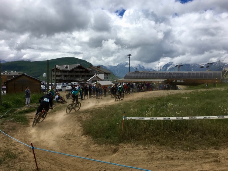 Not far from the DMC lift or finish of Megavalanche 2018 qualifying. The crowd gathered near the 'send to flat' beneath the sign on 'Le Signal' lift.
